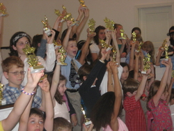 lesson students showing off their trophies