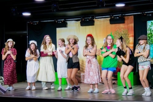 theatre arts photo with children on our stage performing a musical
